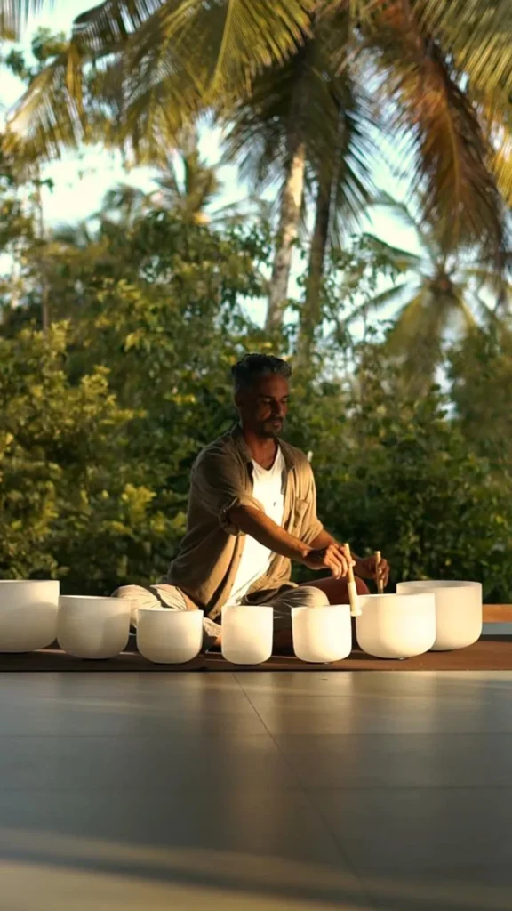 Sunset sound bath meditation training course surrounded by palm trees in Sri Lanka