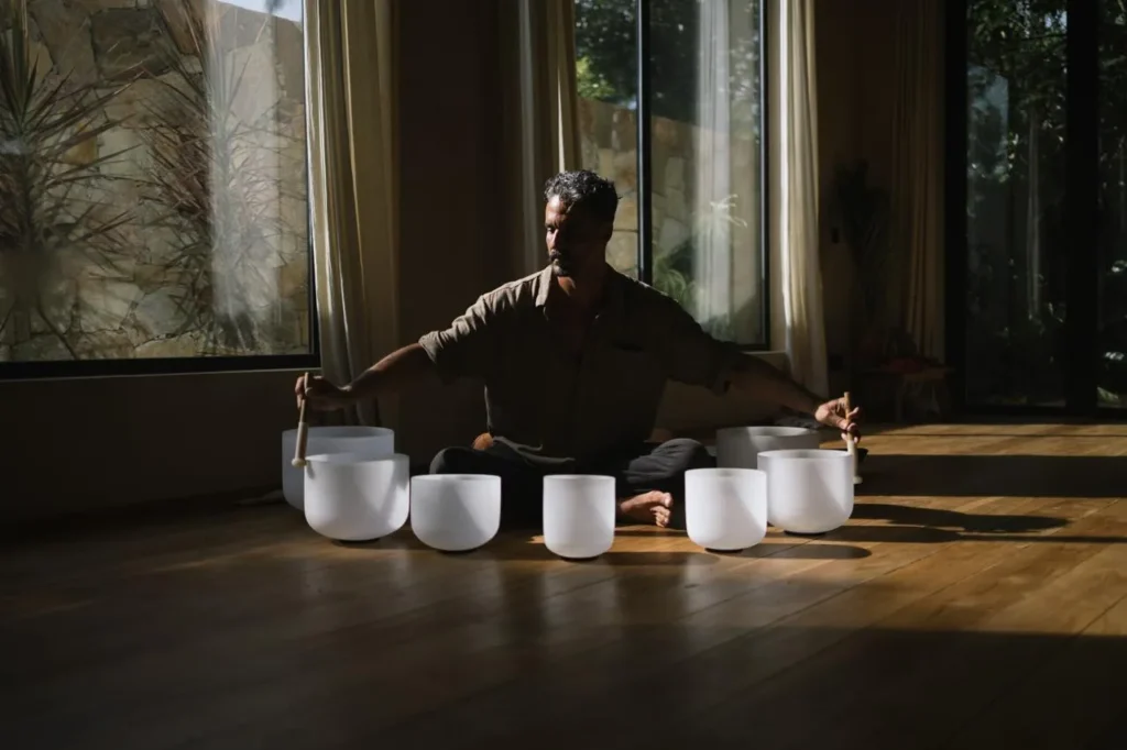Leading teacher guiding a quartz crystal singing bowls sound bath session at Poetry of Sound in Sri Lanka